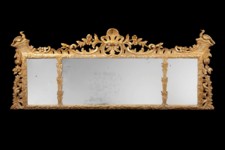 A rare early 18th century carved giltwood overmantle mirror. A rare early 18th century carved giltwood overmantle mirror.
